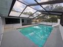 Large screened-in pool with slide and patio area for entertaining with great natural light at 7278 Radcliff St, Spring Hill, FL 34606