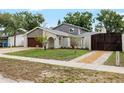 Charming home featuring manicured lawn, stone accents, and a driveway at 8203 Kirkwood Dr, Tampa, FL 33634