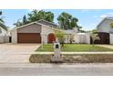 Charming single-Gathering home with a well-manicured lawn and beautiful landscaping at 8203 Kirkwood Dr, Tampa, FL 33634