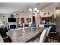 Open-concept living and dining area with modern lighting, hardwood floors, and a cozy fireplace for comfortable living at 8447 Shallow Creek Ct, New Port Richey, FL 34653