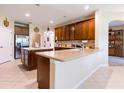 Open kitchen with an island, lots of counter space, tile floors and warm neutral paint at 9313 Lisbon St, Seffner, FL 33584