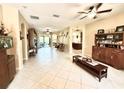 Open living room boasts tile flooring, a ceiling fan, and an open floor plan with multiple archways at 9313 Lisbon St, Seffner, FL 33584