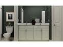 Modern bathroom featuring double sinks, a dark vanity, granite countertop, and framed artwork at 9376 Gladsome Dr, Land O Lakes, FL 34637