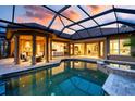 Relaxing pool area with a covered patio, perfect for outdoor entertaining and enjoying the sunset at 984 Chickadee Dr, Venice, FL 34285
