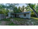 Charming home exterior showcasing a well-maintained lawn, mature trees and an attached garage at 9834 Miramar St, New Port Richey, FL 34654