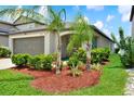 Beautifully landscaped single-story home featuring a well-manicured lawn with palm trees in the front yard at 1015 7Th Nw Ave, Ruskin, FL 33570