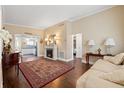 Inviting living room boasting hardwood floors, a decorative fireplace, and views into the kitchen at 1035 58Th N Ave, St Petersburg, FL 33703
