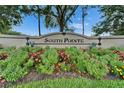 Landscaped South Pointe community sign with colorful flowers and lush greenery at 10449 Hunters Haven Blvd, Riverview, FL 33578