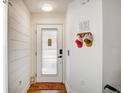 Cozy entryway featuring shiplap accent wall, modern decor, and sleek white door at 11121 Running Pine Dr, Riverview, FL 33569