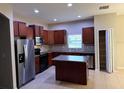 Spacious kitchen features stainless steel appliances, tile flooring, and an island with cabinets at 12202 Fairlawn Dr, Riverview, FL 33579