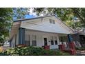 Quaint single-story home featuring a covered front porch and classic architectural details at 1221 E Osborne Ave, Tampa, FL 33603