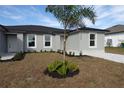 New construction features gray stucco and paved driveway with low-maintenance landscaping at 12223 Kirk Ave, Port Charlotte, FL 33981