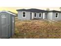 Home construction site with minimal landscaping and portable restroom at 12223 Kirk Ave, Port Charlotte, FL 33981