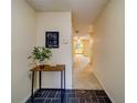 Inviting entryway featuring tile flooring, a charming welcome table, and a view of the home's layout at 1249 Abbey Crescent Ln, Clearwater, FL 33759