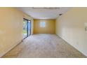 Bright living room with a sliding glass door and neutral wall color at 1249 Abbey Crescent Ln, Clearwater, FL 33759
