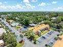 An aerial view of the condo complex featuring lush landscaping, parking, a pool, and well-maintained buildings at 12760 Indian Rocks Rd # 410, Largo, FL 33774