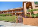 A condo exterior with stairs leading to the second-story condos with balconies, featuring well-maintained landscaping at 12760 Indian Rocks Rd # 410, Largo, FL 33774