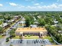 A condo exterior featuring a second-story balcony, landscaping, and plenty of parking, making it a desirable residence at 12760 Indian Rocks Rd # 410, Largo, FL 33774
