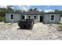 Construction site with a dumpster in front of a new build with gray facade and dark roof at 17099 Carleen Ave, Port Charlotte, FL 33948