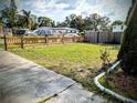 The backyard features new grass and a new wooden fence, offering a private outdoor space at 1906 E 98Th Ave, Tampa, FL 33612