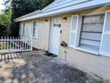 Charming home with a decorative door, white shutters, and a quaint picket fence at 1906 E 98Th Ave, Tampa, FL 33612