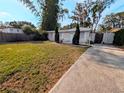 Inviting home with manicured front yard, white picket fence, and charming curb appeal at 1906 E 98Th Ave, Tampa, FL 33612