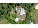An aerial view of the house shows the architectural features and the beautiful treed surroundings at 1931 Jaudon Rd, Dover, FL 33527