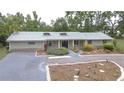 A well-maintained home with a lush front garden and driveway at 1931 Jaudon Rd, Dover, FL 33527