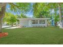 Inviting single-story home featuring a lush green lawn and a freshly painted exterior at 2711 E 22Nd Ave, Tampa, FL 33605