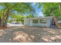 Single-story home with a gray exterior, highlighted by fresh landscaping and a neatly maintained front yard at 2711 E 22Nd Ave, Tampa, FL 33605