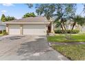 Spacious home with a two-car garage, palm trees and well-maintained landscaping at 3023 Minuteman Ln, Brandon, FL 33511