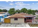 Cozy home featuring a brick facade, a neatly maintained roof, and a charming American flag at 3324 W Saint Joseph St, Tampa, FL 33607