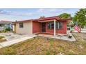 Quaint home featuring brick accents, security bars on the windows, and a well-maintained lawn at 3324 W Saint Joseph St, Tampa, FL 33607