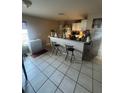 Compact kitchenette with bar seating and basic appliances at 3710 N 57Th St, Tampa, FL 33619