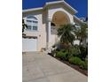 Two-story home with large staircase leading to front door with attached two car garage at 5025 Westshore Dr, New Port Richey, FL 34652