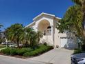 Charming two-story home with lush landscaping, front yard and attached two car garage at 5025 Westshore Dr, New Port Richey, FL 34652
