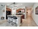 Modern kitchen featuring an island with seating, granite countertops, and stainless steel appliances at 5043 White Chicory Dr, Apollo Beach, FL 33572