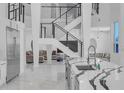 Open floor plan showing the Kitchen, staircase and living room at 5212 62Nd S Ave, St Petersburg, FL 33715