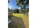 Expansive backyard with lush green grass and mature trees, perfect for outdoor activities and relaxation at 7620 32Nd S Ave, Tampa, FL 33619