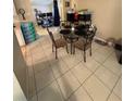Cozy dining area with a glass-top table and chairs, conveniently located near the kitchen at 7620 32Nd S Ave, Tampa, FL 33619