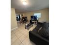 Comfortable living room with tile floors, a large sofa, and plenty of space for entertaining guests at 7620 32Nd S Ave, Tampa, FL 33619