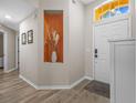Bright foyer with wood-look flooring and niche for displaying decor, bathed in natural light at 8820 Cypress Hammock Dr, Tampa, FL 33614