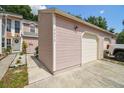Garage exterior featuring a two-car garage with a driveway and view of the home at 9473 N Forest Hills Pl, Tampa, FL 33612