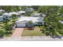 Aerial view of a well-maintained single-story home with a charming front yard and driveway at 9690 41St N St # 0, Pinellas Park, FL 33782