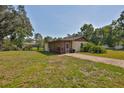 Charming single-story home with a screened-in porch and a spacious front yard at 1019 Lakeside Dr, Seffner, FL 33584