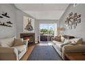 Cozy living room with a fireplace, stylish decor, and access to outdoor space at 10265 Gandy N Blvd # 906, St Petersburg, FL 33702
