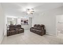 Inviting living area featuring tile floors, neutral walls, and comfortable, modern seating at 10472 Shady Preserve Dr, Riverview, FL 33578