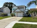 Two-story house with a one car garage, and a well maintained lawn on a sunny day at 10775 Glen Ellen Dr, Tampa, FL 33624