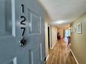 Inviting home entrance featuring wood-look flooring and neutral paint at 10800 Us Highway 19 N # 127, Pinellas Park, FL 33782
