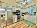 Bright kitchen featuring stainless steel appliances and white cabinetry at 10800 Us Highway 19 N # 127, Pinellas Park, FL 33782